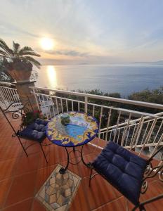 a balcony with a table and chairs and the ocean at La Palombara B&B in Vico Equense +34 photos