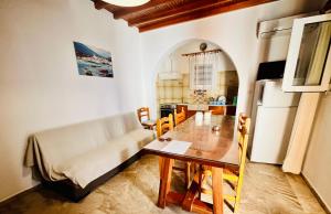 a kitchen and dining room with a table and a couch at Villa Vasilis in Mikonos +34 photos