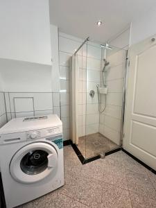 a washing machine in a bathroom with a shower at Maxima in Bamberg +10 photos