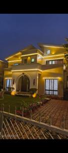 a large white house with a fence in front of it at Gardenia 29 in Raichak