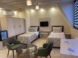 a hotel room with two beds and a tv at Hotel Mavirem in Istanbul