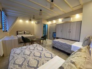 a hotel room with two beds and a table and chairs at Hotel Mavirem in Istanbul +24 photos