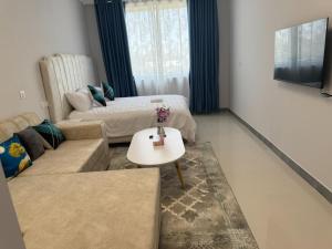 a living room with a couch and a table at Cozy homes sabaki in Nairobi