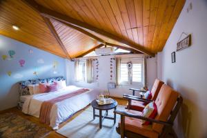 a bedroom with a bed and a table and a chair at Alaya Stays Country Ville - 3 BHK Pet Friendly Villa with Lush Garden & Kids Room in Kokliyal Gaon +96 photos