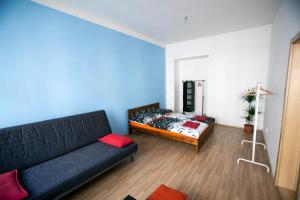 a living room with a couch and a bed at Comfortable Apartment Vlkova in Prague
