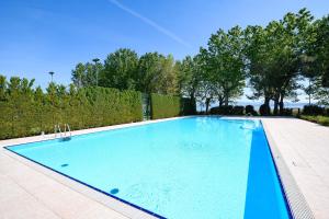 a large swimming pool in a yard at Acquarius Resort Sirmione - MGH in Sirmione