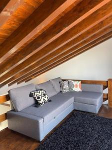 a couch with pillows on it in a living room at Casa Amarela Sao Luis in Odemira +11 photos