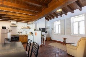 a kitchen with a white refrigerator and a table at Casa Amarela Sao Luis in Odemira