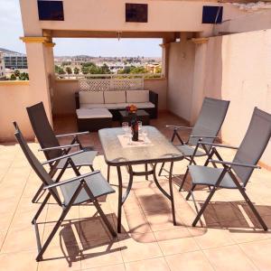 a patio with a table and chairs on a balcony at Apartment with roof terrace, Mar de Cristal in Mar de Cristal +44 photos