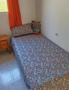 a bed in a corner of a room at Sandy Bunker 2 bed apartment and pool in Alicante +13 photos