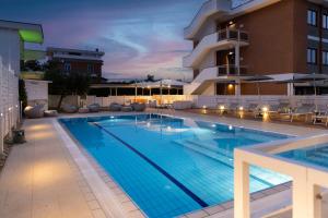 a large swimming pool in front of a building at Best Western Hotel Rome Airport in Fiumicino
