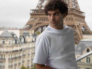 a young man standing in front of the eiffel tower at Pullman Paris Tour Eiffel in Paris