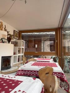 a bedroom with two beds and a fireplace at Chalet Valeruz in Canazei