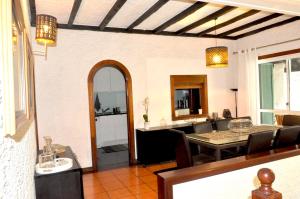 a dining room and living room with a table at Refúgio Guest House in São Vicente