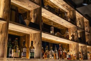 a bar with lots of bottles of alcohol at CoDE Pod – The CoURT - Edinburgh in Edinburgh