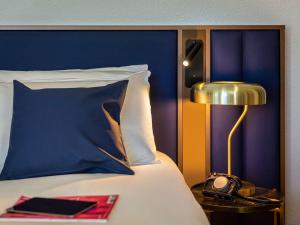 Postel nebo postele na pokoji v ubytování Mercure Toulouse Aeroport Blagnac