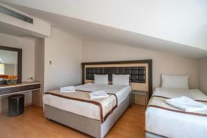 Postel nebo postele na pokoji v ubytování Tu Casa Gelidonya Hotel