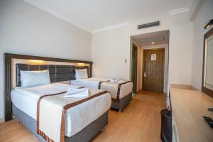 Postel nebo postele na pokoji v ubytování Tu Casa Gelidonya Hotel