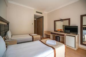 Postel nebo postele na pokoji v ubytování Tu Casa Gelidonya Hotel