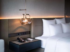 Voodi või voodid majutusasutuse Pullman Quanzhou Shuitou toas