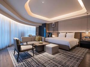 Voodi või voodid majutusasutuse Pullman Quanzhou Shuitou toas