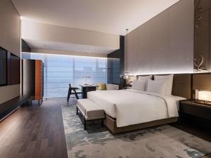 Voodi või voodid majutusasutuse Pullman Quanzhou Shuitou toas