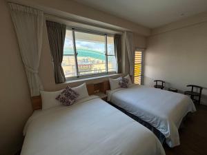 Кровать или кровати в номере Ding Dong Homestay