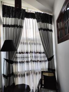 a black and white curtain in a room at Villa Uppugama in Etagama
