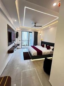 a bedroom with a large bed and a television at Leisure homes in Lucknow