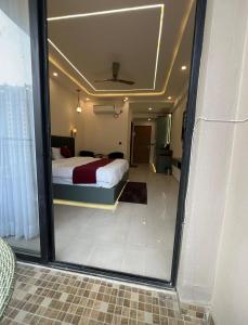 a bedroom with a bed and a large glass window at Leisure homes in Lucknow +8 photos