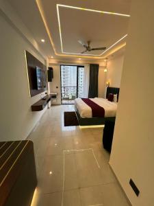 a hotel room with a bed and a television at Leisure homes in Lucknow