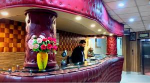 a man sitting at a bar in a restaurant at Hotel City View Peshawar in Peshawar