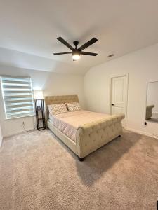 a bedroom with a bed and a ceiling fan at Spacious 6 Bedroom Home- Near Historic McKinney in Melissa