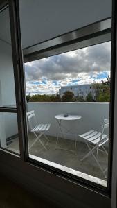 a view of a table and chairs from a window at 13 Apartments 3BR R&P Living in Halle an der Saale