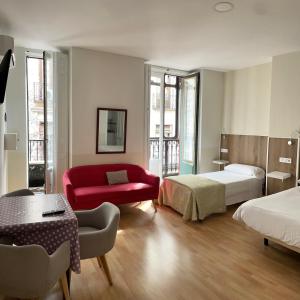 Postel nebo postele na pokoji v ubytování Apartamentos Mayor Centro