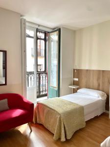 Postel nebo postele na pokoji v ubytování Apartamentos Mayor Centro