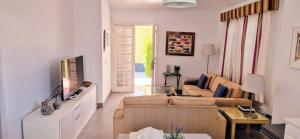 a living room with a couch and a table at HANDICAP 7 Bungalow 4 in San Bartolomé