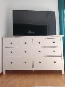 a white dresser with a television on top of it at Apartment mit Wellness im Rennweg in Regensburg