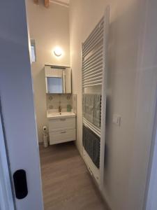 a small bathroom with a sink and a mirror at Malebný byt pod hradem Křivoklát in Křivoklát