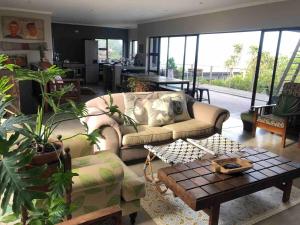 a living room with a couch and a table at Westbrook Beach Haven in Westbrook