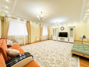 a large living room with a couch and a television at # 10 Яркая и светлая квартира in Atyraū