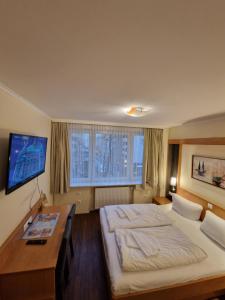 Postel nebo postele na pokoji v ubytování Hotel Wikinger Hof