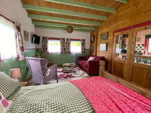 a bedroom with a bed and a couch at The Fabulous flower hut in Llanfynydd