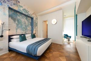 a bedroom with a large bed and a flat screen tv at Moon River Luxury Apartment in Rome