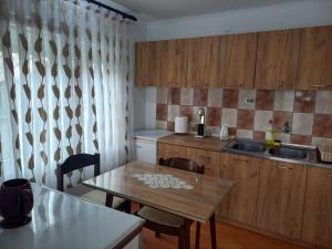 a small kitchen with a table and a sink at Belinda Apartment in Gevgelija