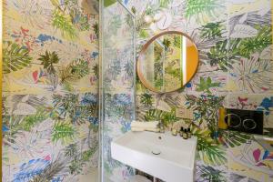 a bathroom with a sink and a mirror at Moon River Luxury Apartment in Rome +35 photos