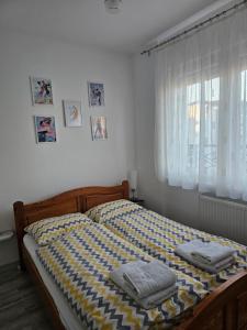 a bedroom with a bed with two towels on it at Apartman Sofija in Banja Koviljača