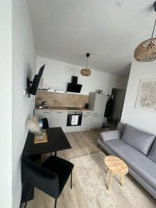 a living room with a couch and a table at Place2stay Gloggnitz1 in Gloggnitz +12 photos