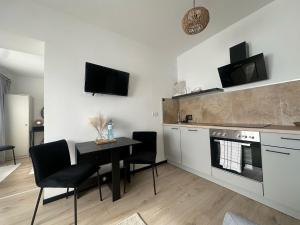 a kitchen with a table and chairs and a stove at Place2stay Gloggnitz1 in Gloggnitz