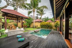 an image of a house with a swimming pool at The Kampung Ubud Villa in Ubud